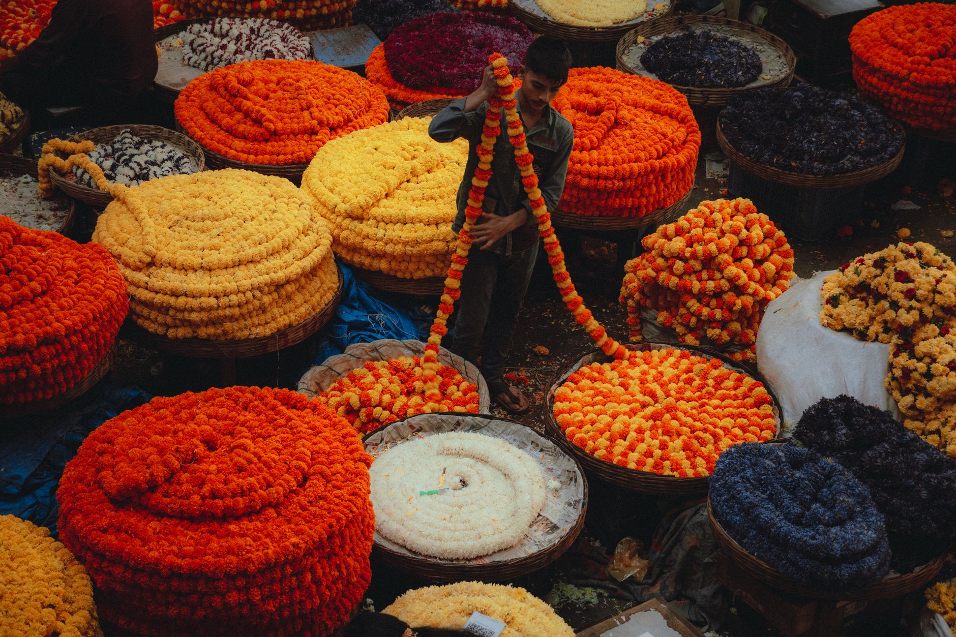 Strings of marigold garlands and fresh flowers at Bangkok's Pak Khlong Talat flower market