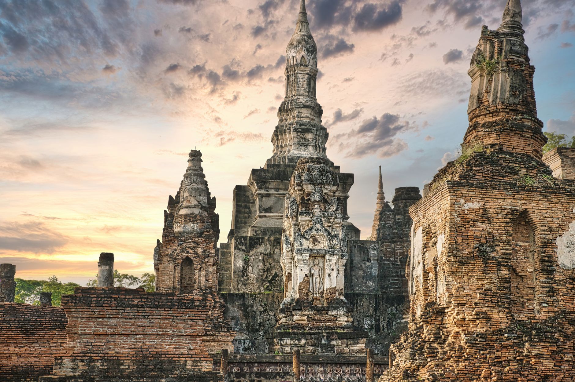 Ancient Buddha statue and temple ruins at Sukhothai Historical Park, Thailand