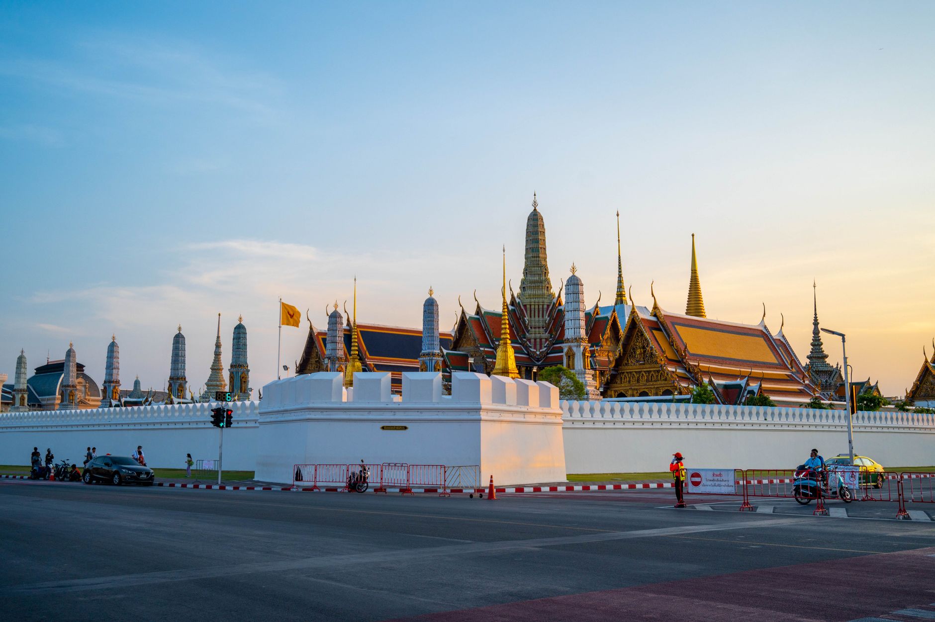 The Grand Palace in Bangkok at sunset, with its golden spires and traditional Thai rooflines