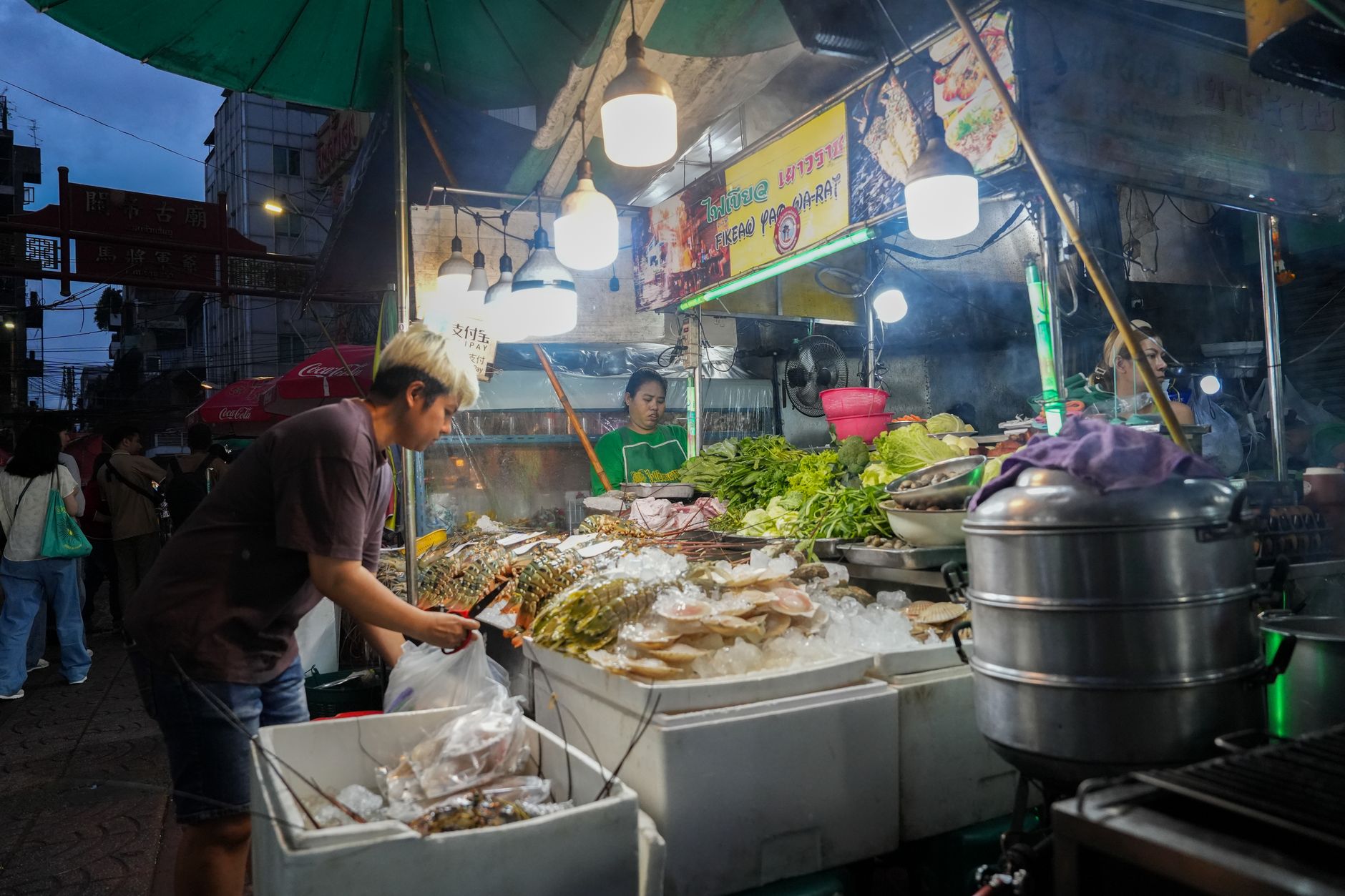Food stalls lit up at night on Yaowarat Road in Bangkok's Chinatown